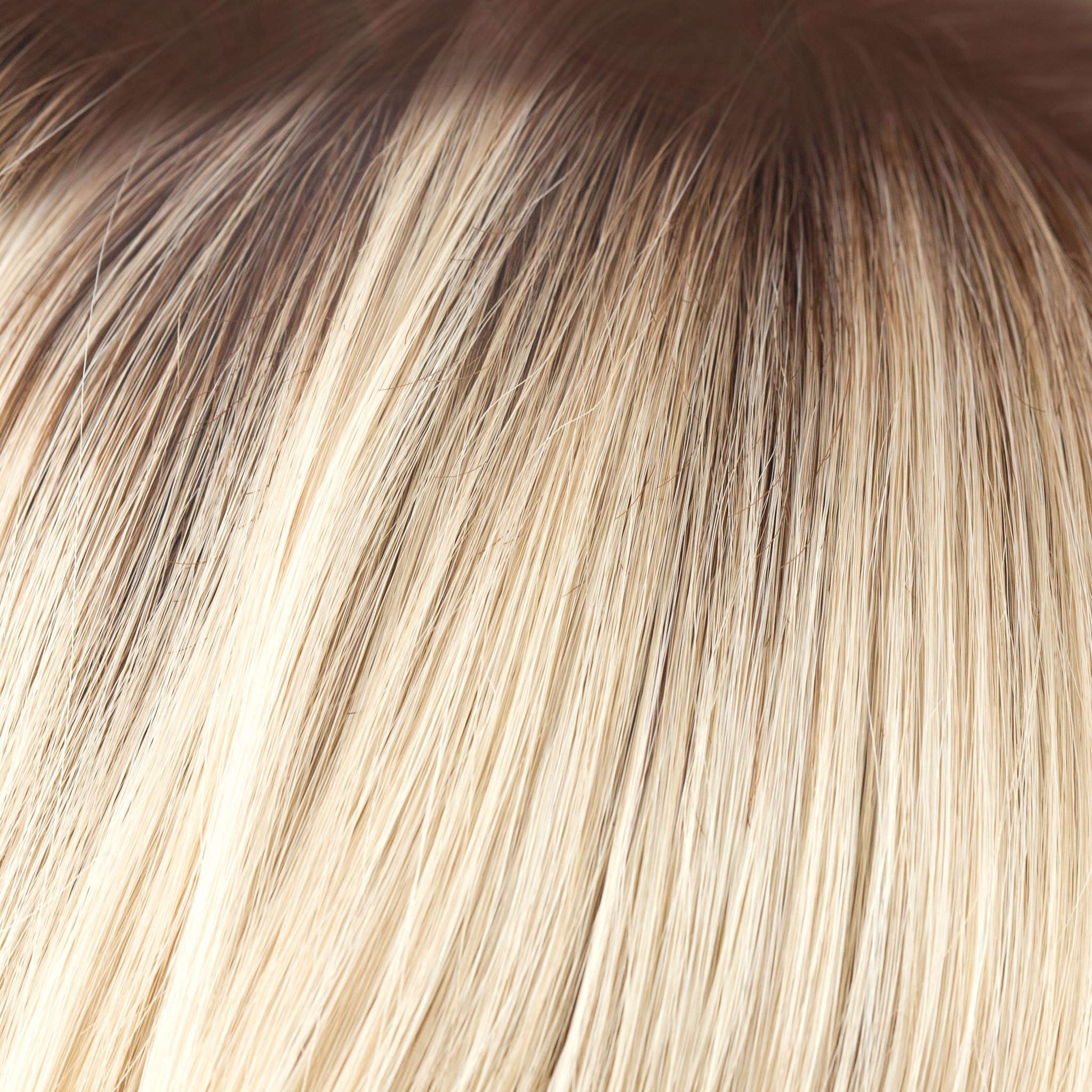 Champagne-R  -  A luxurious color with many fine tones of blond. Cream blonds, champagne hues and pale gold undertones make the blond a work of art! The medium warm brown root gives it the most natural of regrowths and keeps it looking very realistic.