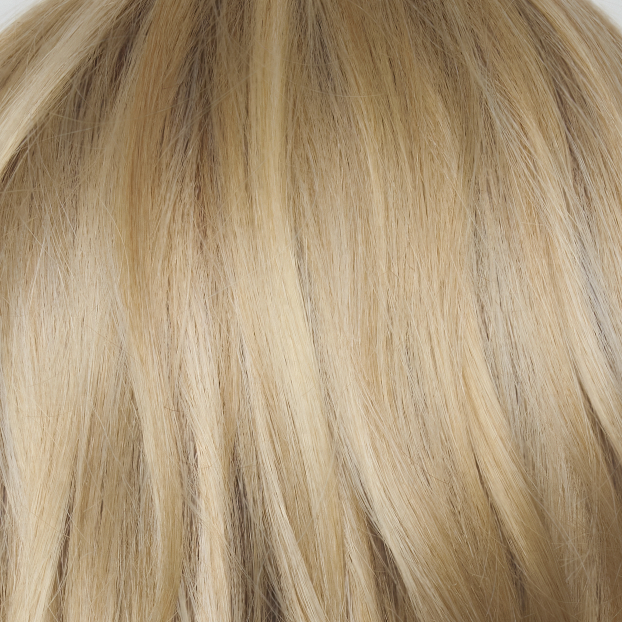 Sandy Cream Blond-R - This shade features soft golden sand tones with subtly rooted color for a natural regrowth effect. This blend of beige brown, honey, and creamy blonde transitions beautifully into lighter shades, creating a warm, versatile look that flatters any skin tone. A perfect choice for effortless, honey-warm blonde style.