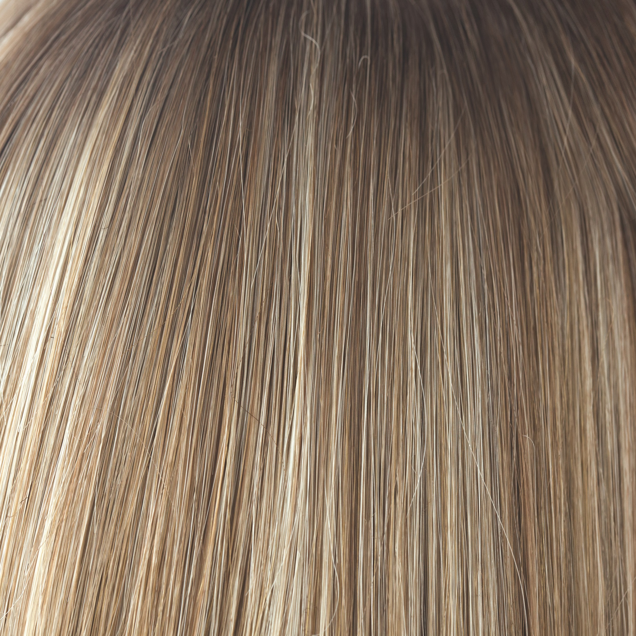 A natural and the root tone is a medium gold honey brown. There is a mix of white blonde highlights and strawberry blonds. Complemented with medium velvet brown undertones.